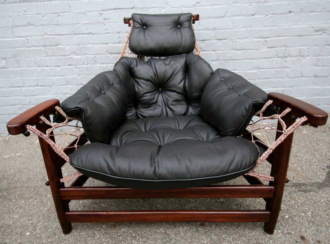 Jangada chair and ottoman by Jean Gillon in Brazilian jacaranda upholstered in black leather.