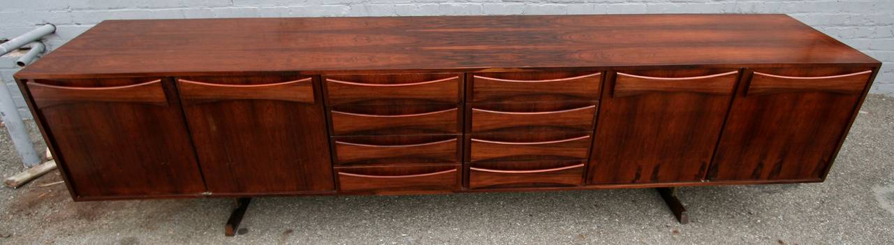 Brazilian jacaranda sideboard from the 1960s by Liceu de Artes with bow tie handles.  There two sets of drawers in the middle and a larger cabinet with a shelf on either end.