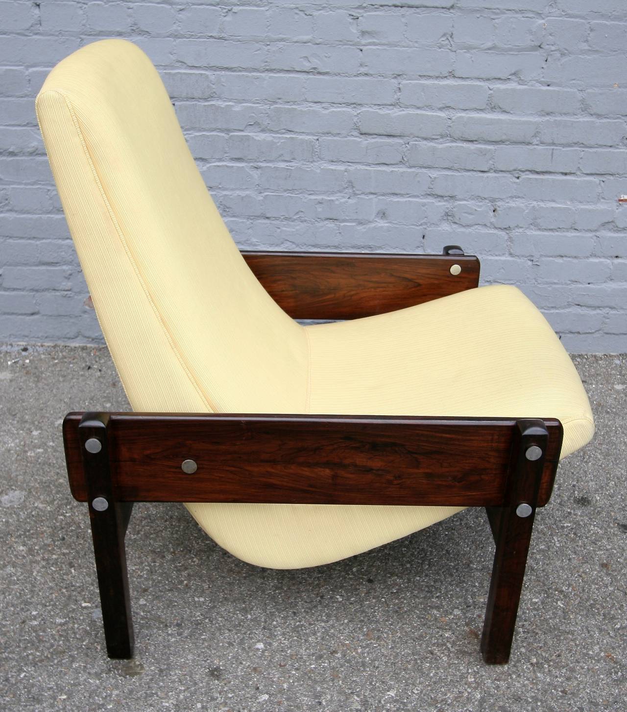 Pair of 1960s Brazilian jacaranda Vronka armchairs by Sergio Rodrigues with yellow upholstery. The chair is featured in the Icatu book 