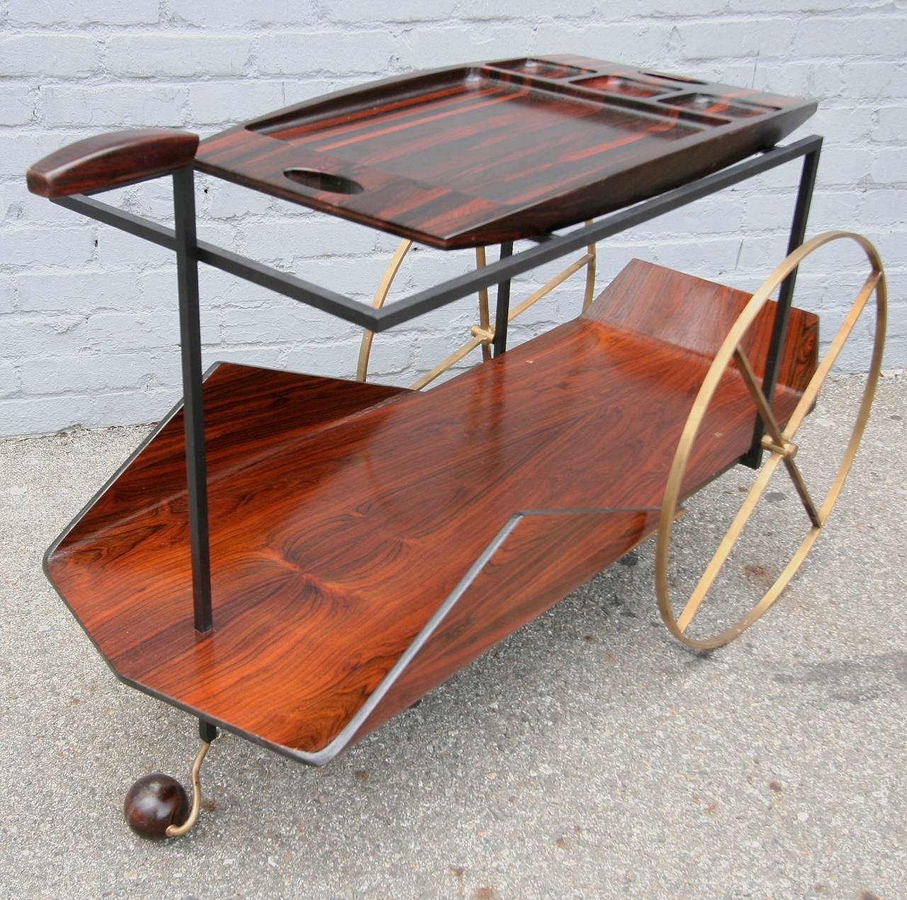 Jorge Zalszupin’s iconic 1950s Carrinho de Cha bar cart made in Brazilian jacaranda with brass wheels and ball foot.  The top shelf is a removable tray.