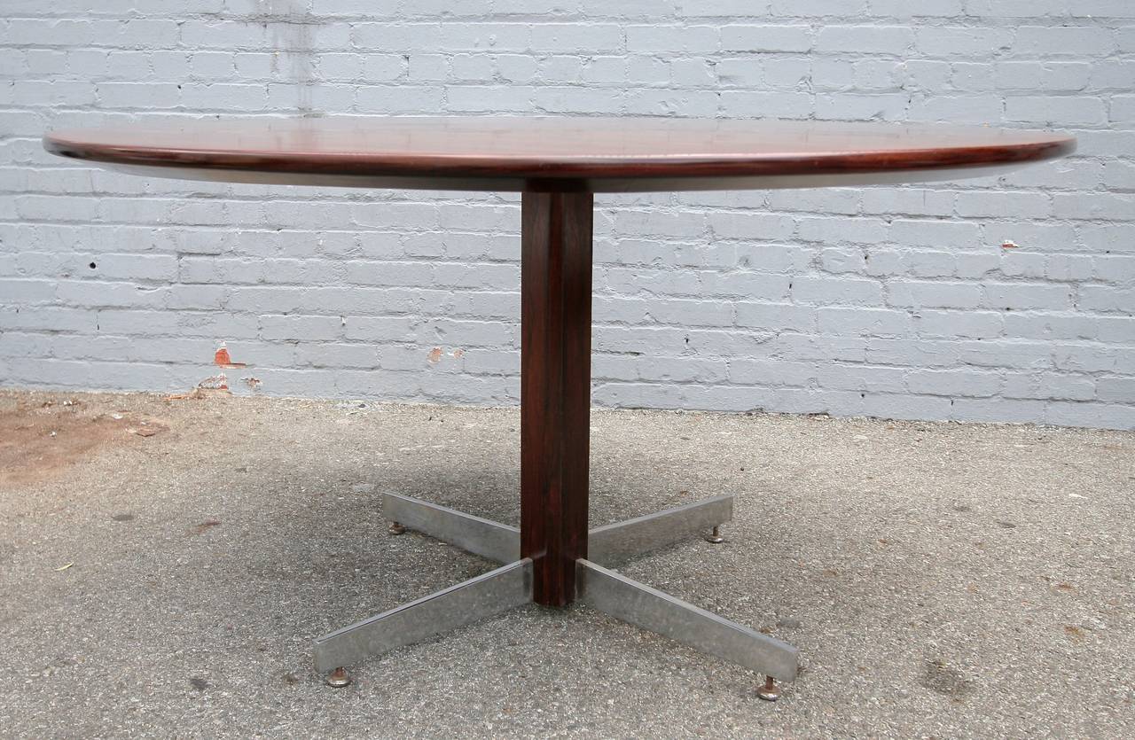 L'Atelier 1960s Brazilian jacaranda round dining table with metal feet.
