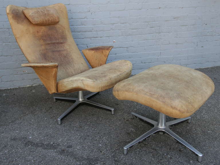Weathered lounge chair with ottoman from 1950s.
Chair measures: 34.5