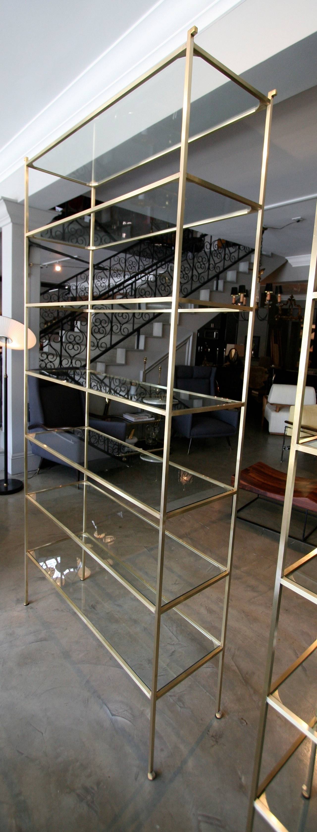 Grande étagère en laiton sur mesure avec sept étagères en verre.  Fabriqué à la main en laiton massif à Los Angeles par Adesso Imports. Peut être fabriqué dans des dimensions et des finitions personnalisées. Prix à l'unité, pas à la paire.