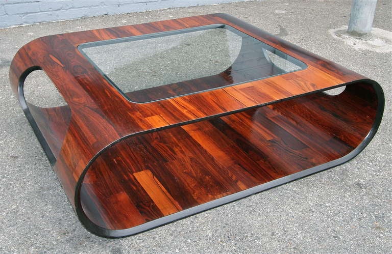 Gorgeous pair of coffee tables by Jorge Zalszupin.  Oval in shape from the side, the parquet jacaranda veneer covers the entire surface, even the bottom.  Can be purchased individually.

Please call or use the contact dealer link below to reach us