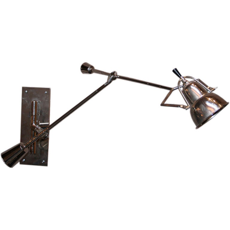 A beautifully preserved example of a chrome wall lamp by Edouard Buquet from the 1920s with a weight balance arm and a pivoting metal shade.

The dimensions are adjustable. Listed are the height of the backplate, width of the bracket lamp and