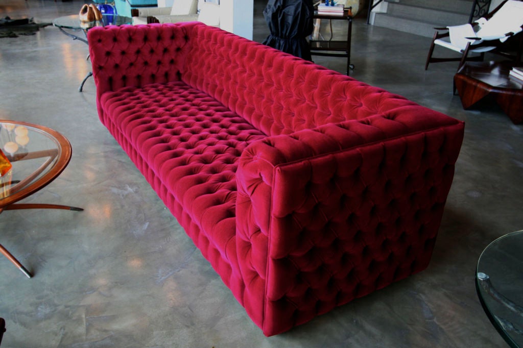 red velvet tufted sofa