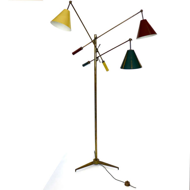 This amazing adjustable floor lamp was designed by Angelo Lelli and produced in 1953. This rare color combination is completely original. This lamp even retains it's original brass floor switch. The brass end caps of each arm have the Angelo Lelli