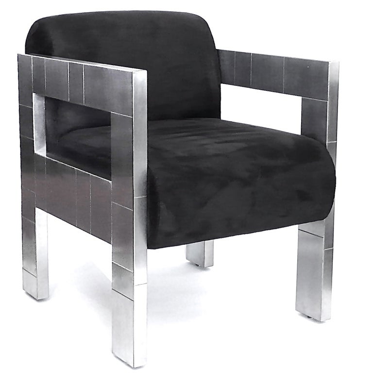 These rare Paul Evans Chairs were produced by Paul Evans, Inc. in 1976. They are the cityscape pattern in brushed chrome. The chairs retain their original labels. They are upholstered in black ultra-suede and are in great condition. Can be sold in
