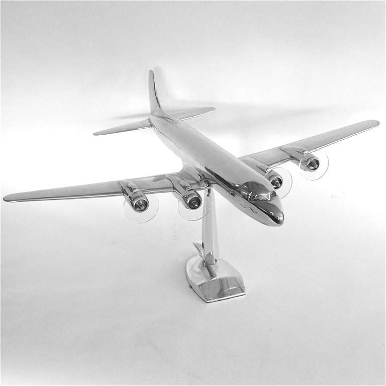  This is a very rare 1950's scale model aluminum DC7. It was a promotional table top airplane made by Douglas to promote it's latest model. It has it's original sculptural abstract soaring eagle base and 4 lucite propellors that spin when you move