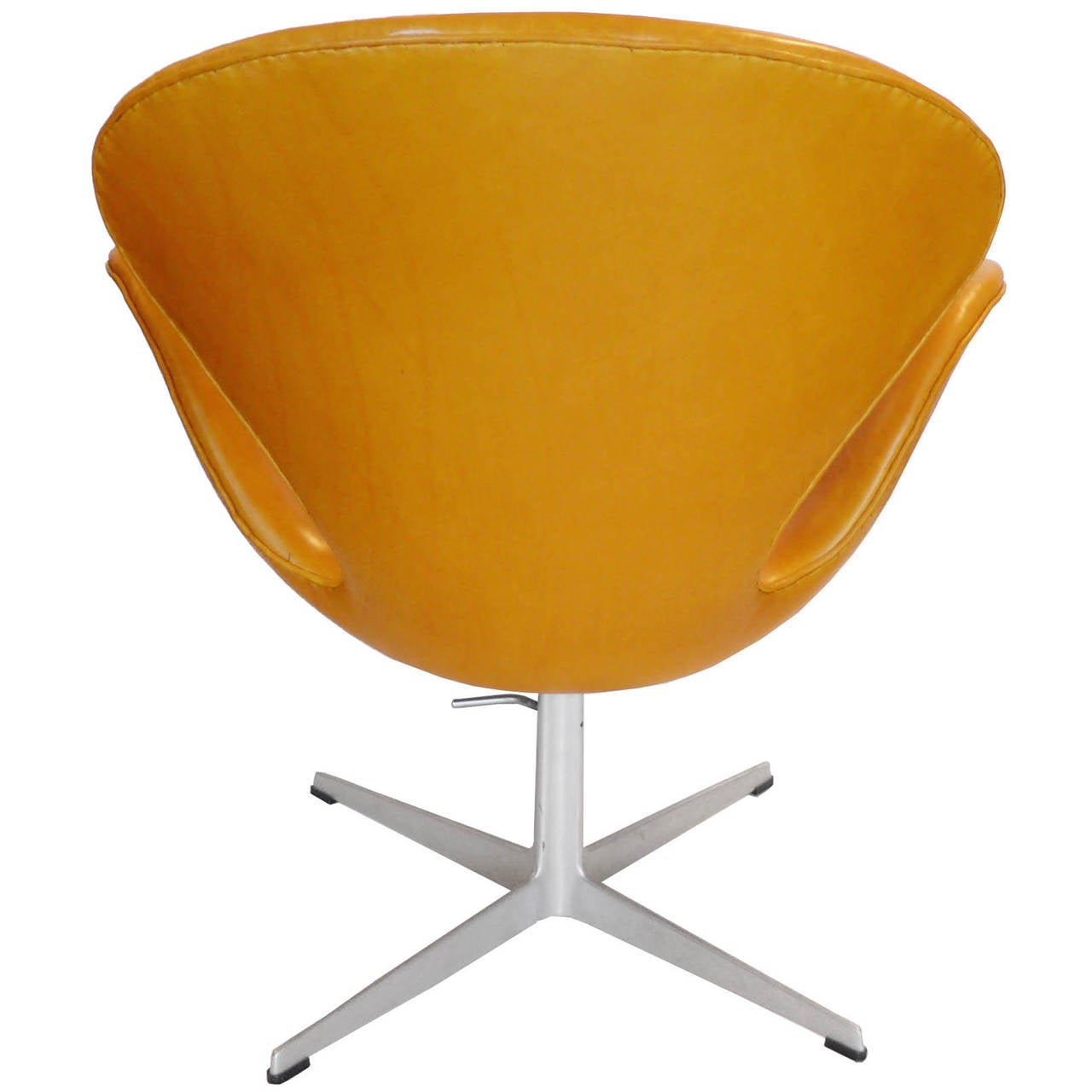 This is a rare saddle tan leather adjustable swan chair. It is a great chair. This variation was manufactured by Fritz Hansen for a very short time. The seat adjusts from 16.5”-20”. It can adjust in height from the standard swan lounge height to a