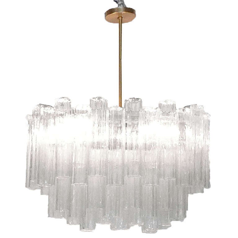 Large oval shaped chandelier with shimmering tronchi glass crystals hangs on a brass stem. Perfect for over a dining table. This chandelier holds six incandescent standard based light bulbs and currently hangs 36