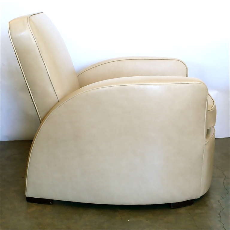 This great chair has been recovered in a beautiful latte foam color leather. It has an internal mechanism that allows the seat and back to tilt back up to 4 inches with body pressure. They were often used in studio screening rooms at Paramount