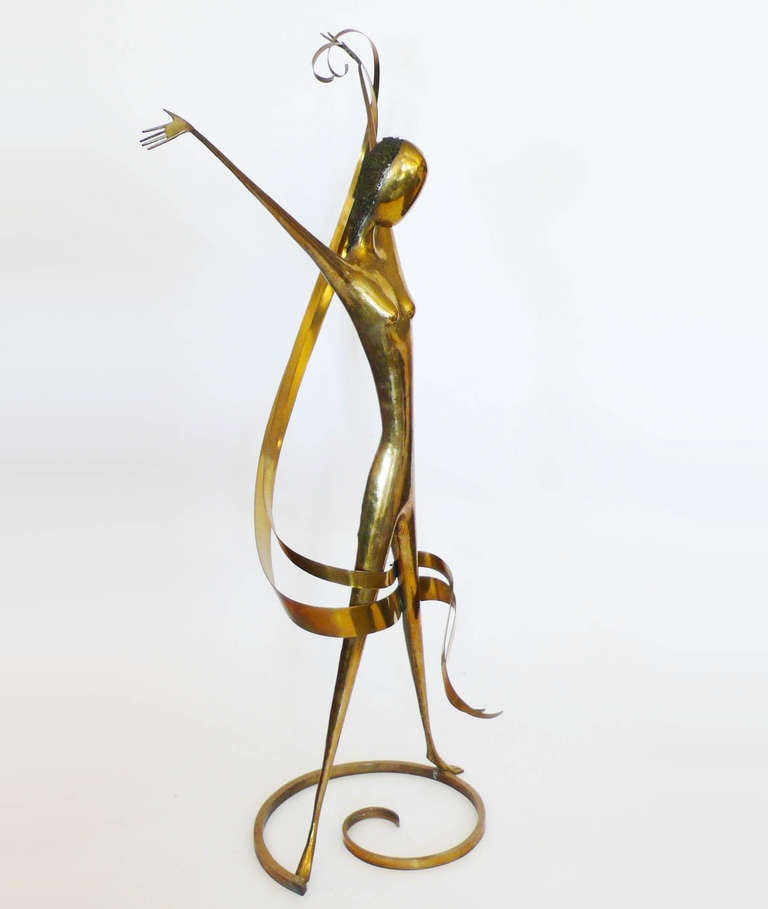 This large brass Hagenauer sculpture was made by hand. The figure is hand hammered. The hair is formed of masses of coiled and compacted brass wires. The scarf is rolled brass and the base is a coiled brass bar. It is signed with the Hagenauer mark,