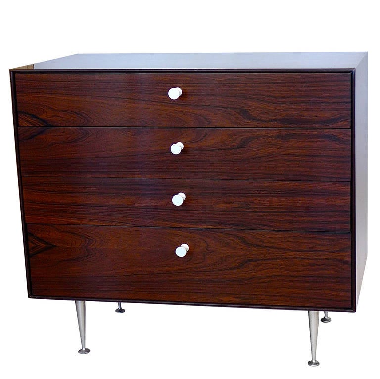 Exquisite rosewood Thin Edge series dresser with porcelain pulls and aluminum legs in excellent condition. Retains the original label. All original dividers in drawers are present. Completely functional as well as beautiful.