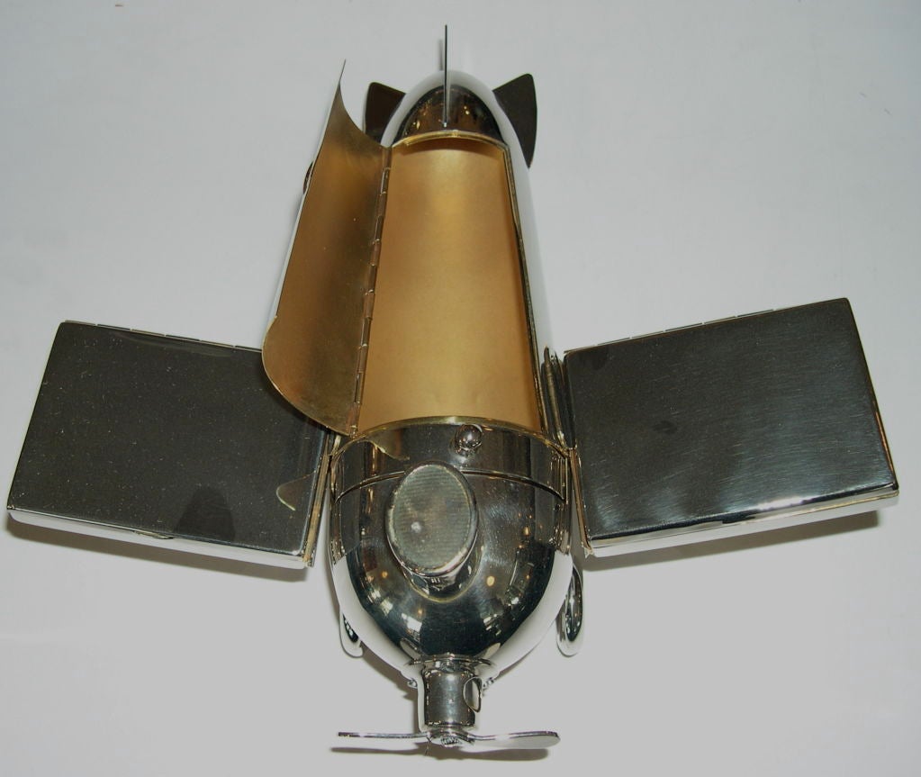This great airplane was made in the 1930's by J.A.Henkels. It holds a combination of many parts consisting of two cigarette cases, cigar case, cigar tip cutter, match striker and four ashtrays. The striker top lifts to hold matches, ashtrays pull