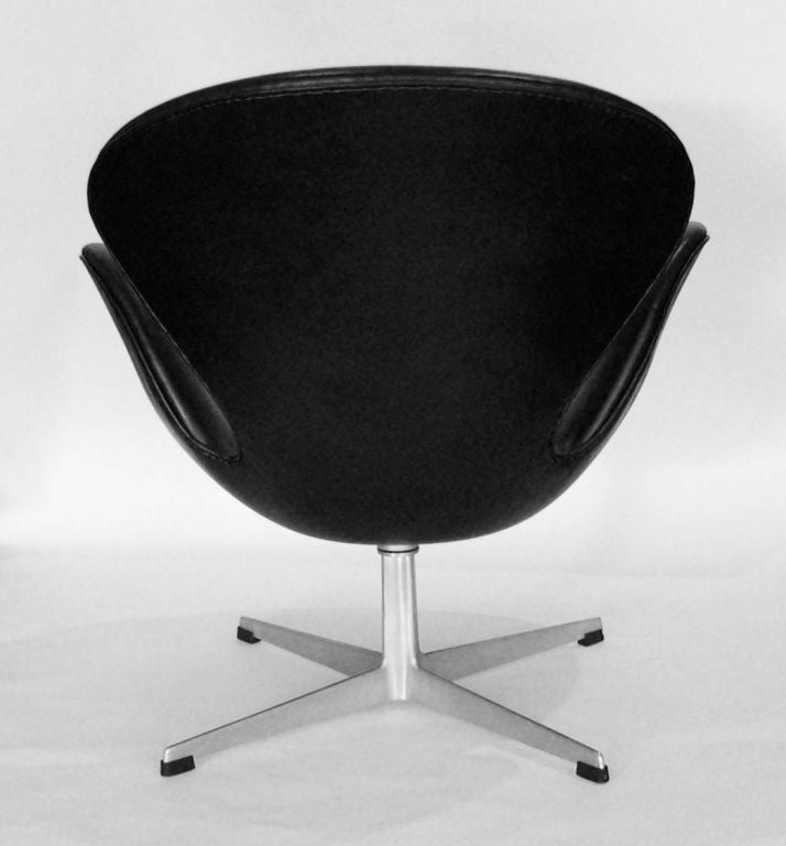 These original swan chairs are covered in vintage back leather. They have the Fritz Hansen logo and 