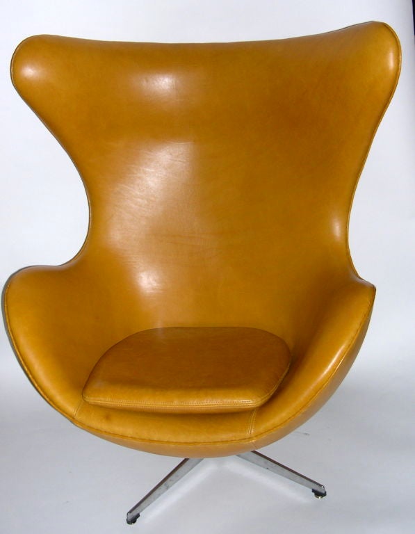 This is a beautiful vintage tan leather egg chair and ottoman. Designed by Arne Jacobsen and produced by Fritz Hansen, this chair has the Fritz Hansen molded stamp impressed in the metal base. The leather is soft and pliable with only minor