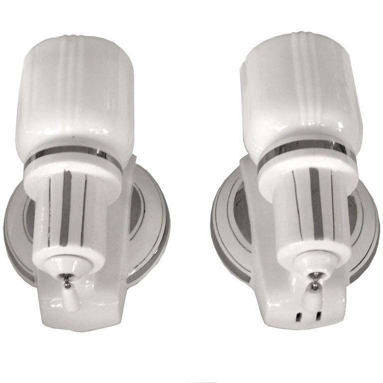 These great white porcelain sconces have their original glass shades. The platinum painted details and original porcelain pulls make these a very special pair of sconces