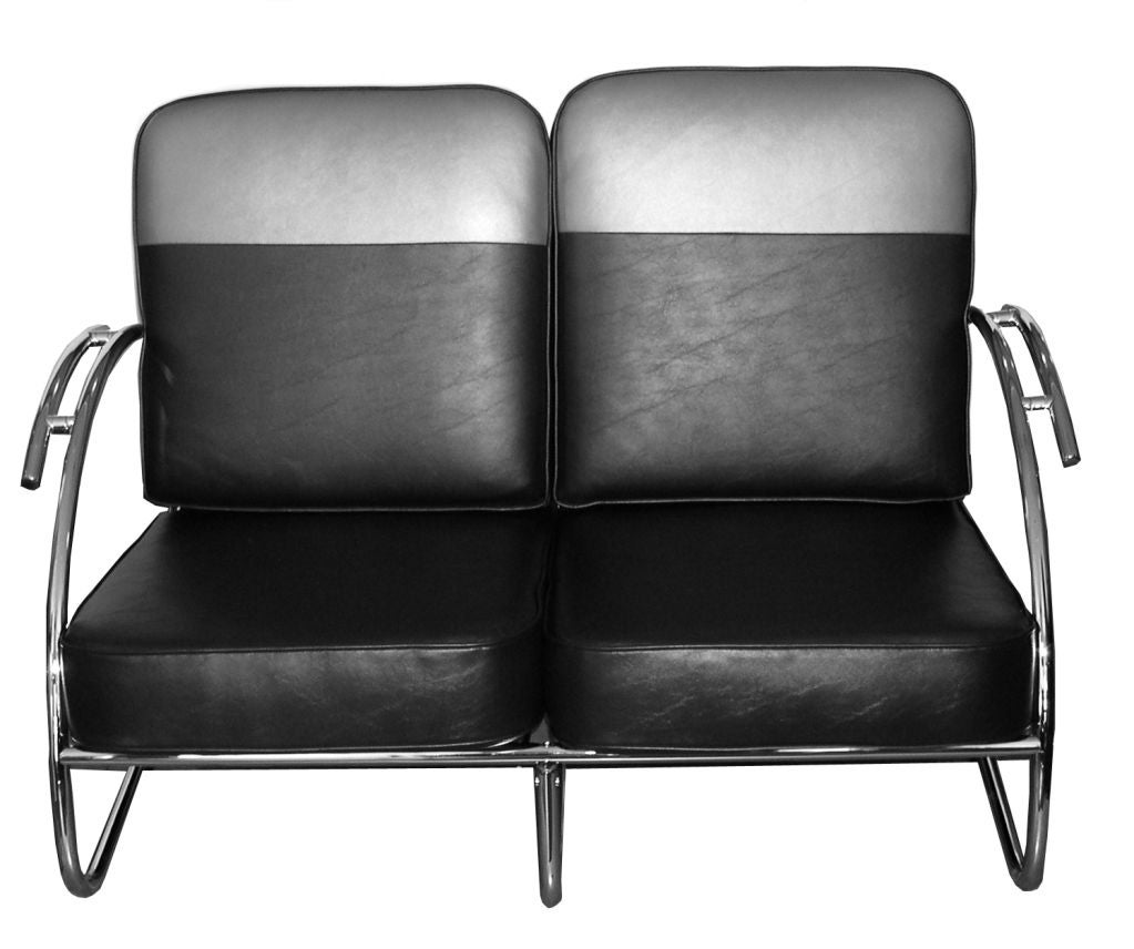 This loveseat has been attributed to KEM Weber by several auction houses. It's low profile and sleek curving arms create a look that epitomizes the American Streamline design movement. The additional curved armrests add an extra dimension of design