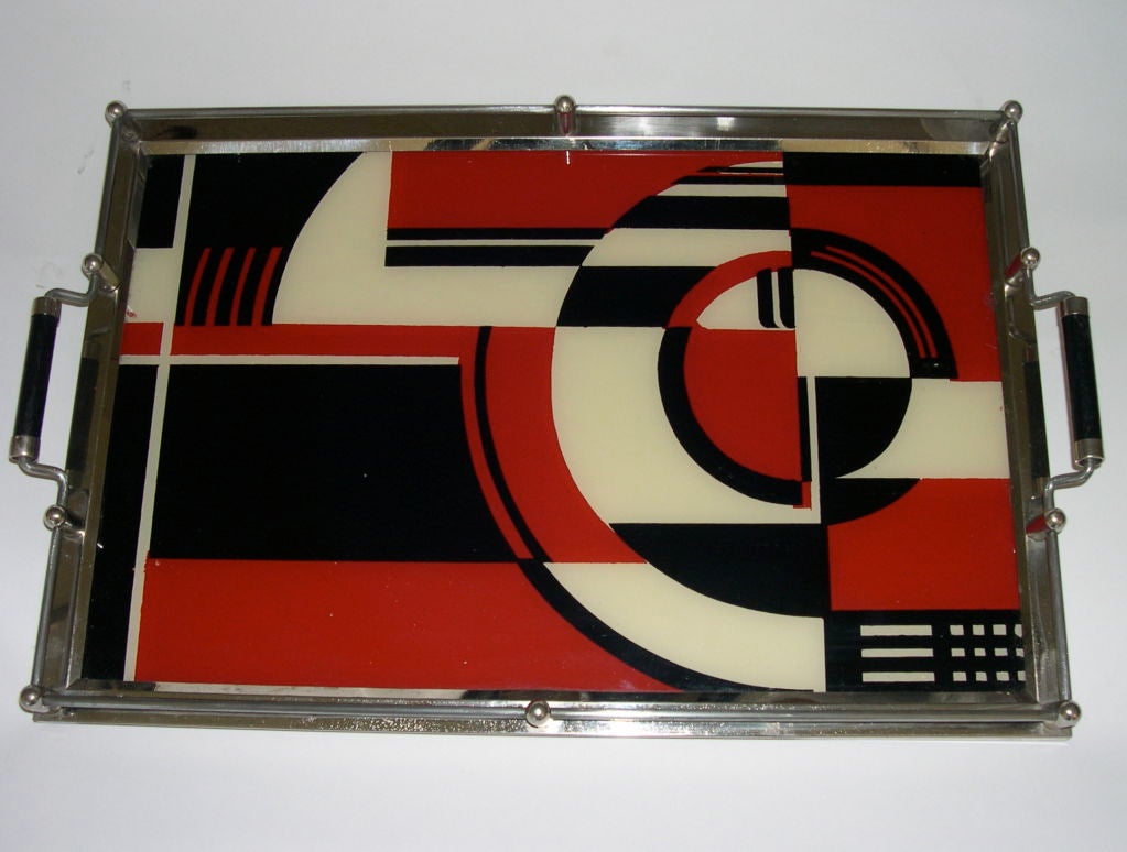 This is the iconic 1930's Jazz Cocktail tray. Pictured in many Art Deco reference books over the years and held in several museum collections, this tray epitomizes the bold graphic designs of the early 1930's. It is made of silkscreened glass with