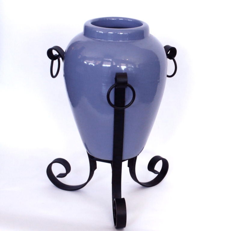 This original 1930's periwinkle blue urn and stand is really nice. The thick walled urn is in excellent condition. It is very typical of the urns that graced the courtyards and walkways of the Mediterranean and Spanish homes built in the late 1920's
