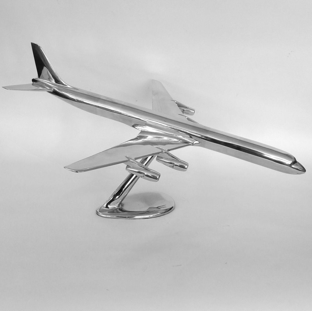 This large scale DC8 Stretch is from 1965. It has it's original base which has a pivot connection allowing the plane to be placed in many positions. These airplane<br />
models were produced in small quantity of cast aluminum and used as