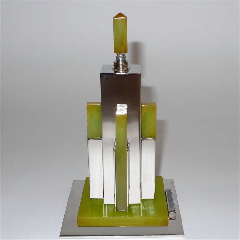 This wonderful sculptural lighter epitomizes the architectural design of the late 1920's - early 1930's skyscrapers of Manhattan. It works on a very basic principle. There is cotton inside the body of the lighter that is saturated with lighter