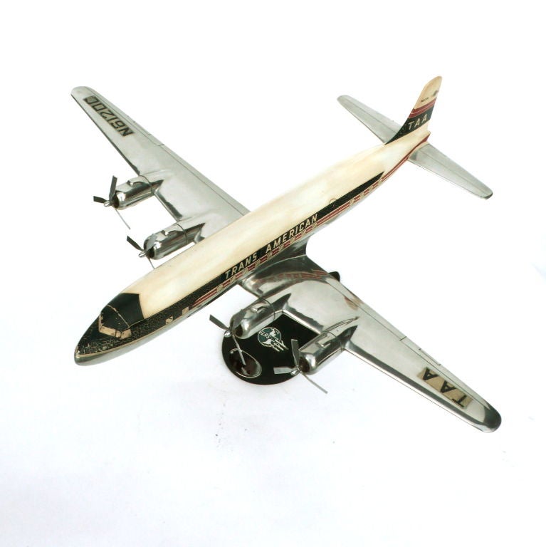 This is an exceptional airplane model made by Douglas Aircraft Co. This shinny polished aluminum plane sits on it's original Douglas base. The plane swivels. It has it's original decals, paint and spinning propellors.