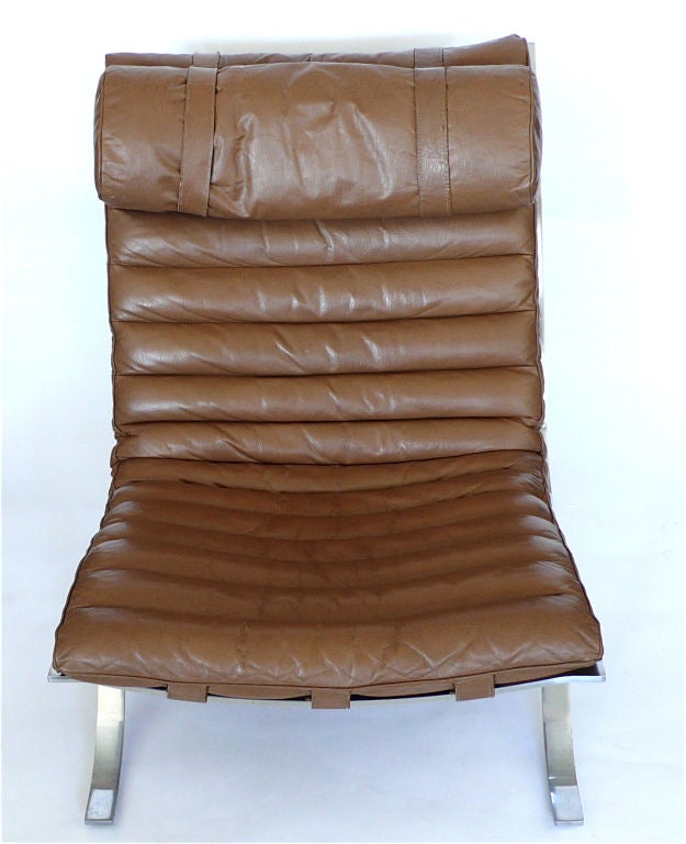 This classic chair and ottoman still retain their original Bloomingdale Brothers tag. It is a great original. The leather is soft and pliable. The padding is fine. The heavy steel base curves for maximum comfort, lifting your legs slightly to rest
