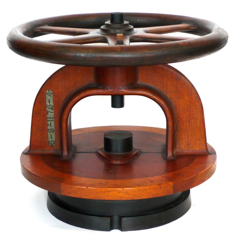 This fabulous piece evokes a machine age form that is both historic and futuristic at the same time. It is in two parts and the wheel moves freely. It appears to be made of several woods sculpted and laminated with original black accents.