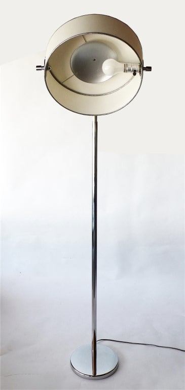 This is an extremely rare lamp designed by Walter Von Nessen in the 1930's. The shade pivots from a downward light up to an uplight position. This lamp retains it's original metal interior reflector, paper shade and finial.