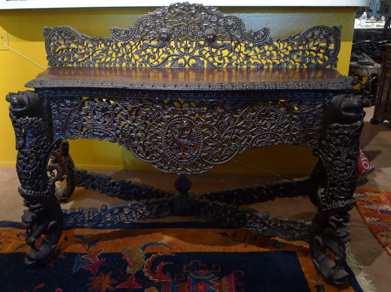 Superlative hand-carved detail found on this late1800s Burmese alter table or console. We also have a highly detailed Burmese Settee listed on our storefront.