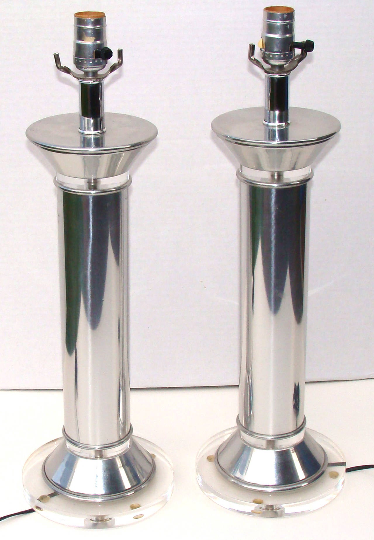 Polished aluminum cylindrical form lamps.
Note: Lucite base is 7