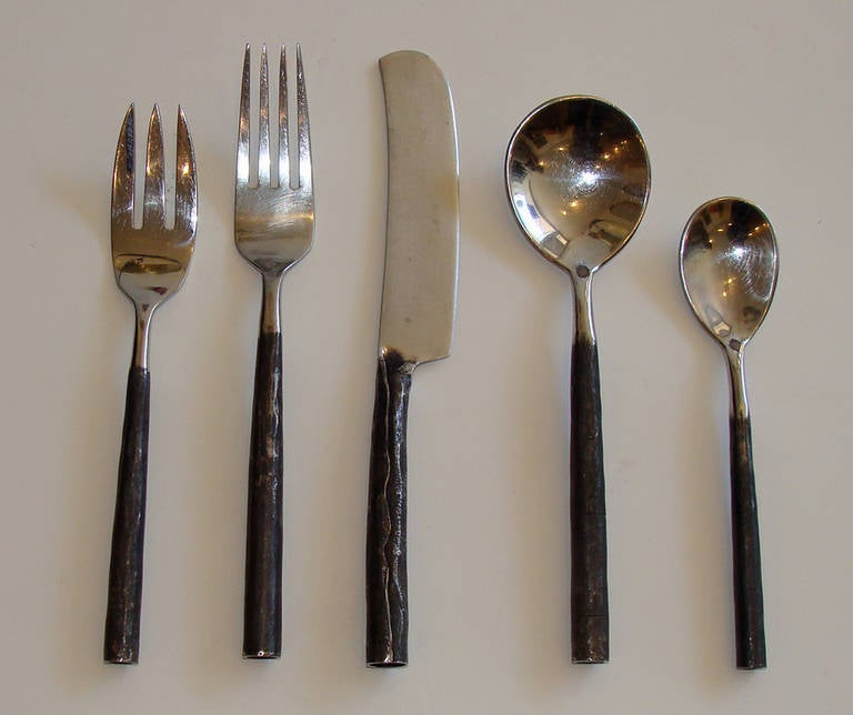 Fantastic hand-wrought stainless steel flatware retailed by the legendary Soho retailer Turpan-Sanders in the early 1980s.

Set of four five-piece place settings. (Knife is 9