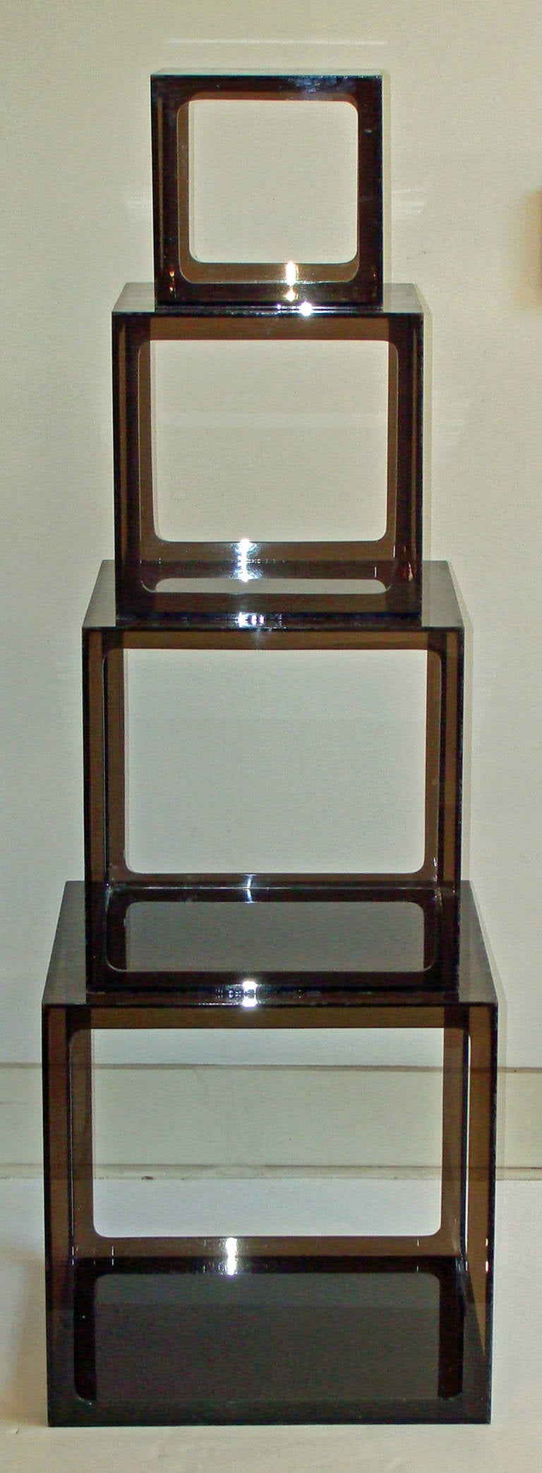 Wonderful nesting set of four smoky gray lucite cube tables. 
Rare find in original 1960's condition.