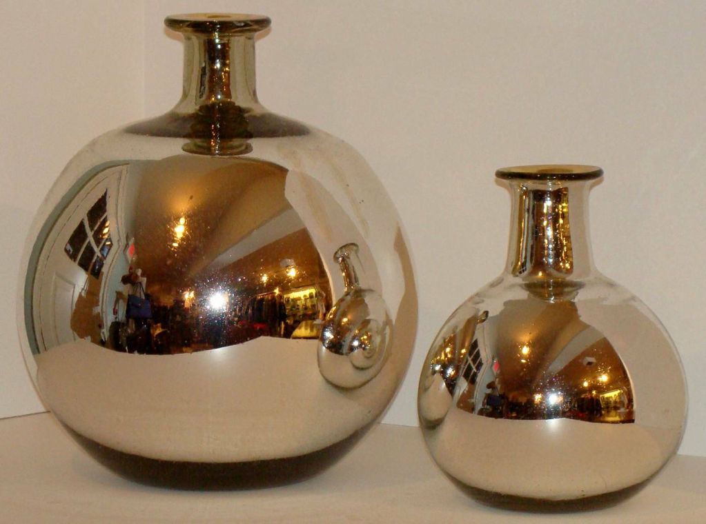 A set of two mercury glass vases of spherical, bottle form.<br />
Similar in form in two different sizes, 10