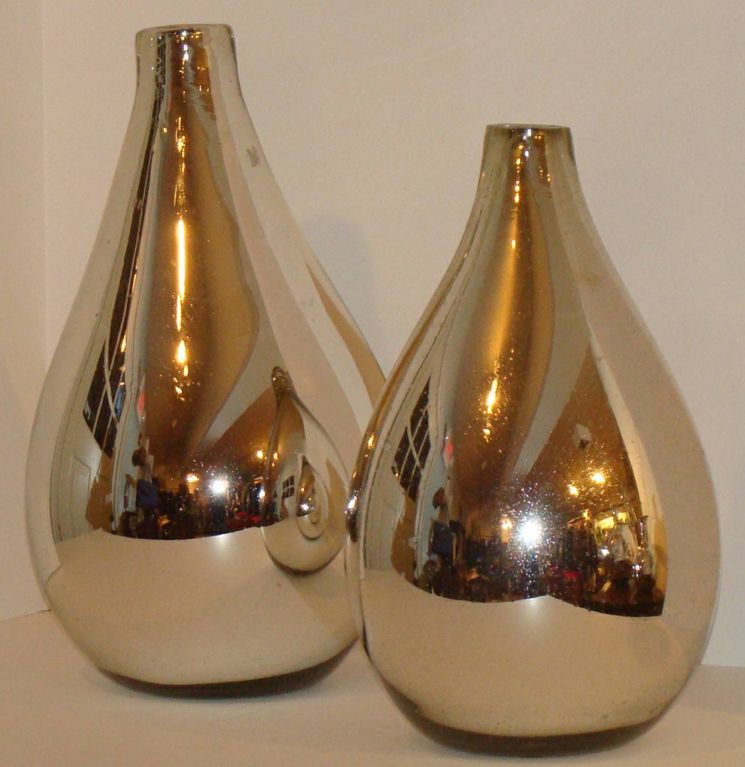 Two mercury glass vases of similar pear-shaped form.  Beautiful as stand-alone accents or converted to table lamps.  15