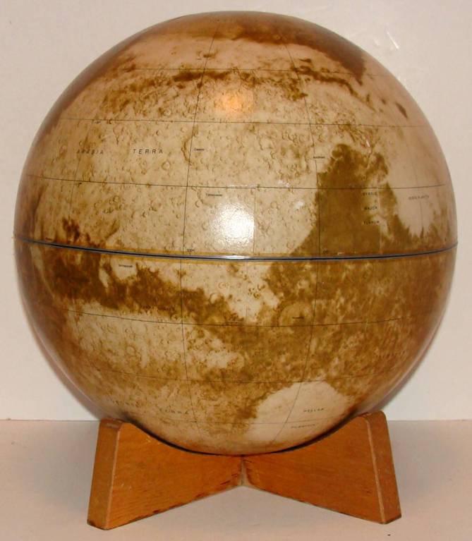 12 inch globe of the planet Mars. Rests on wood base.  Illustrated mapping based on imaging generated by the NASA Viking 1 and 2 spacecraft which touched down on Mars' surface in 1976. It was heralded as the most complete exploratory to date.