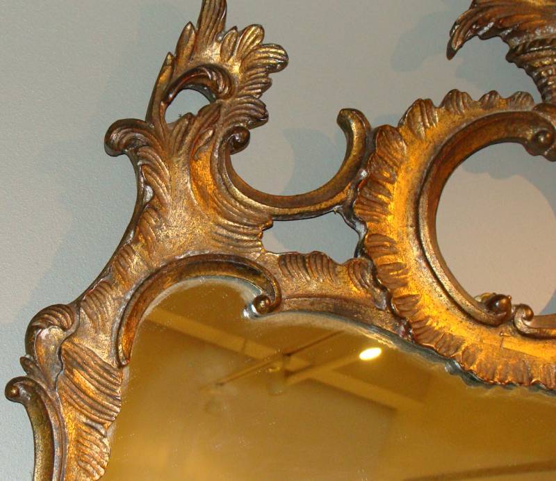 Carved giltwood mirror in the baroque/modern taste.  Labeled on verso.