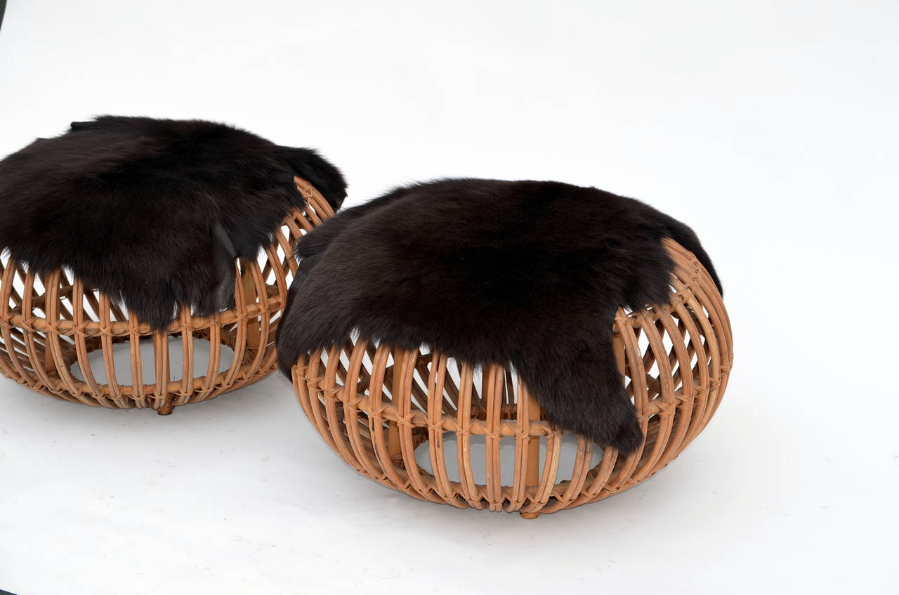 Woven Pair of Round Rattan Ottomans in the Style of Franco Albini with Fur Covers