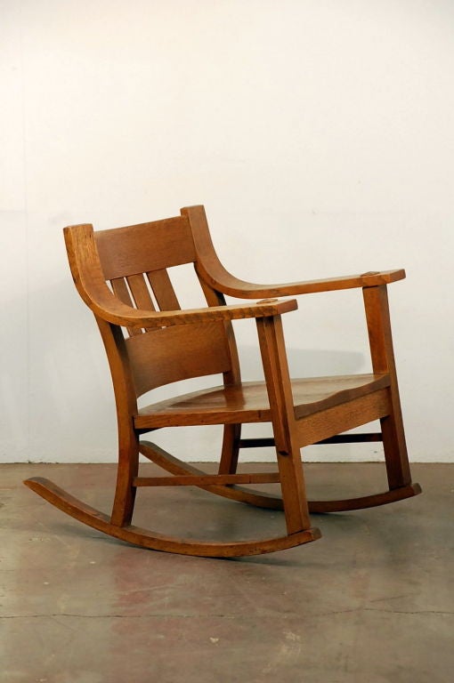 Unusual (low back and wide) Arts & Crafts oak rocking chair. 15 in seat height.