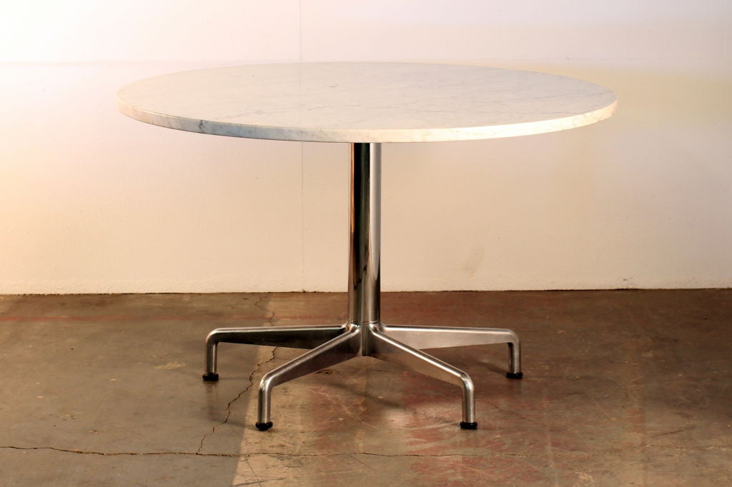 Segmented base and marble-top round dining table by Eames for Knoll.