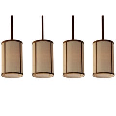 Set of Four 'Cylindre' Patinated Brass & Raffia Pendant Lights by Design Frères