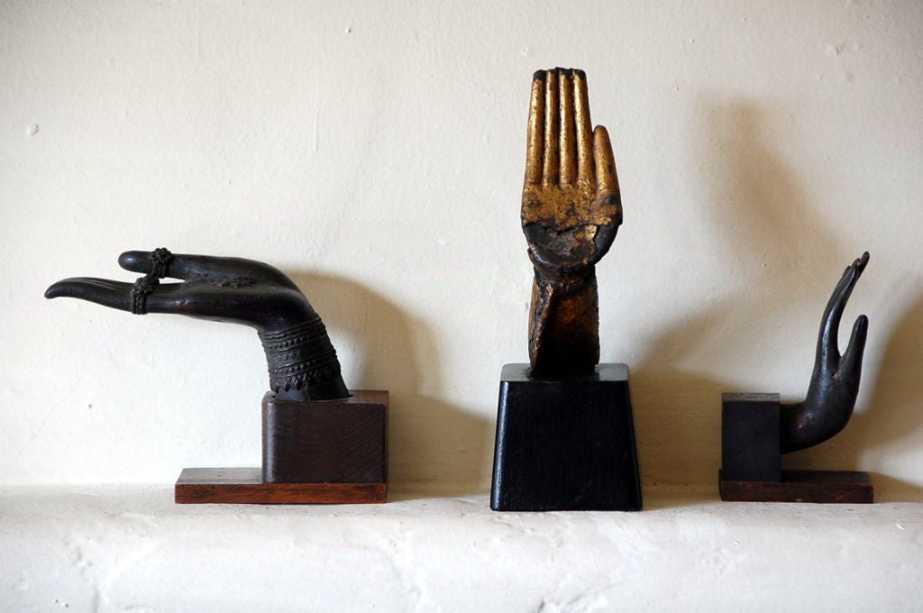 Collection of antique bronze Buddha hands on stands