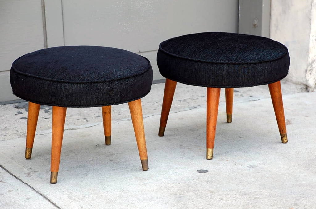 Pair of mid-century low stools with brass sabots