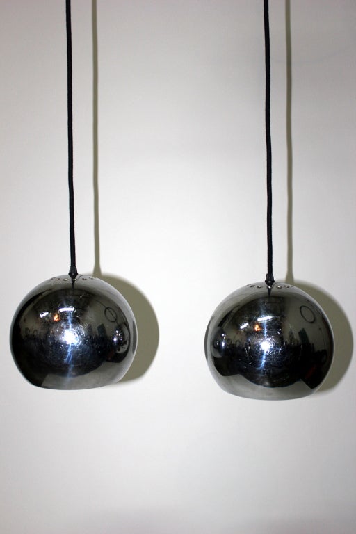 Pair of chromed globe French 60's lights. Current total drop: 69 in. (cord can be shortened). 9 in. diameter globes.