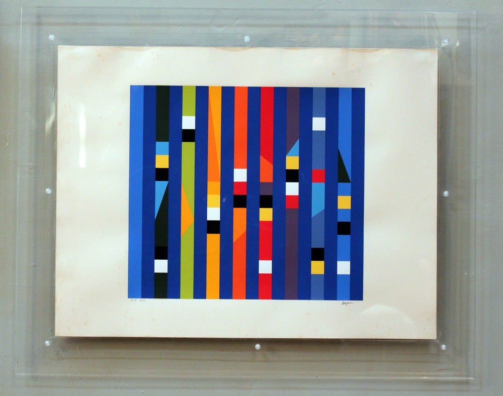 Lucite framed print by Yaacov Agam.

Yaacov Agam (b. 1928) is an Israeli sculptor and experimental artist best known for his contributions to optical and kinetic art.

Yaakov Agam was born Yaakov Gipstein on 11 May 1928, in Rishon LeZion, then