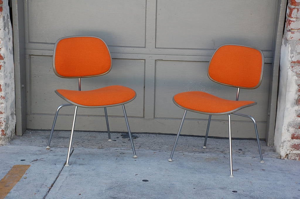 Pair of orange DCM chairs by Charles Eames for Herman Miller
