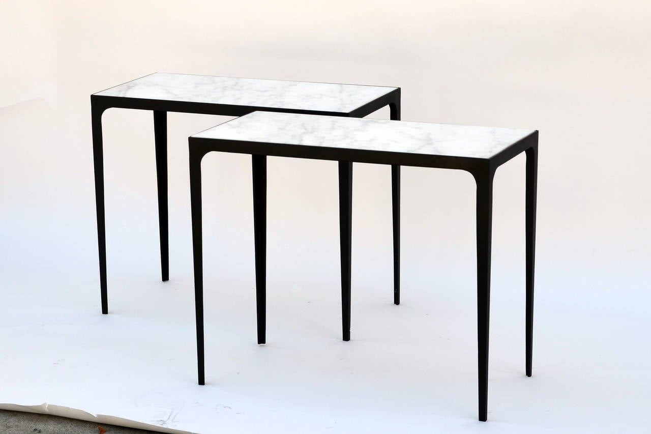 Pair of chic blackened iron and honed marble side tables. In the style of Jean-Michel Frank.