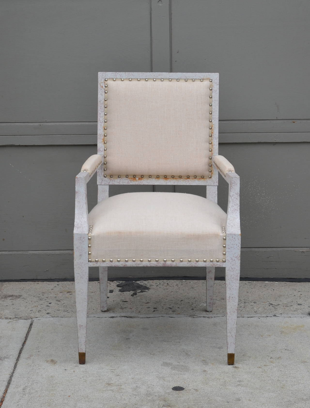 Chic French 40's Armchair in the style of Andre Arbus. Brass sabots. White washed frame, natural linen upholstery.
